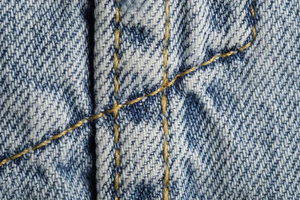 Blue jeans fabric macro seam pattern blurred background. Denim background texture for design. — Stock Photo, Image