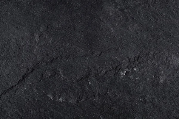 Fondo de pizarra negra gris oscuro o textura de piedra natural . — Foto de Stock