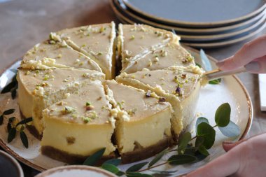 Kadının elleri pastayı kesti. Üstte görüntü 