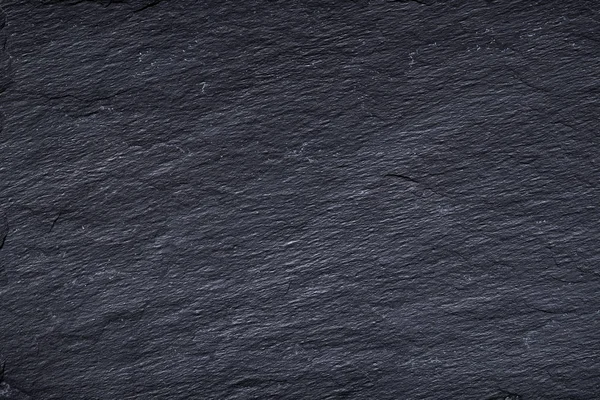 Fondo de pizarra negra gris oscuro o textura de piedra natural . — Foto de Stock