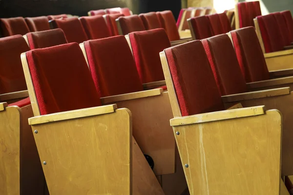 Empty red velvet seats for spectators in the theater or cinema. Red theater seats — Stock Photo, Image