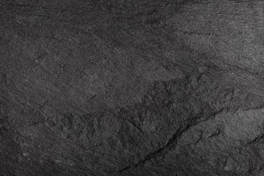 Koyu gri arkaplan ya da doğal taşın dokusu. Yakın çekim için siyah tahta.