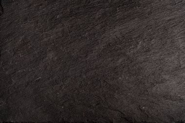 Koyu gri arkaplan ya da doğal taşın dokusu. Yakın çekim için siyah tahta.