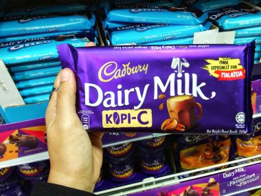 Kadınlar süpermarkette çikolata tutan el. Seçilen odak. Bulanık.