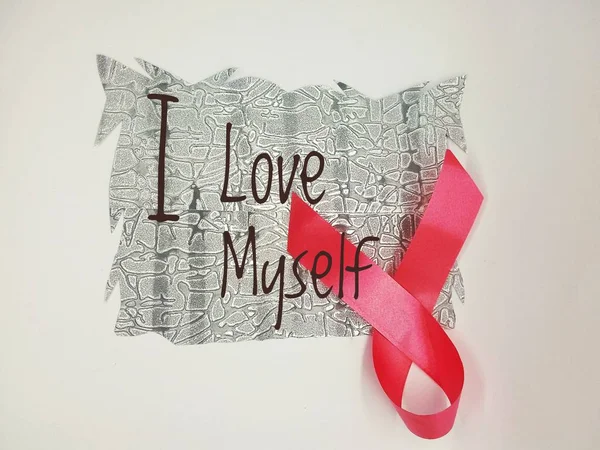 cancer awareness ribbon with \'I love myself\' words on white background.