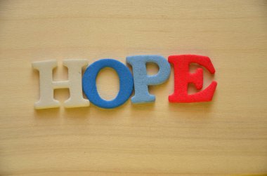 hope word on wooden cubes on colorful background