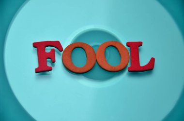 word fool on abstract background