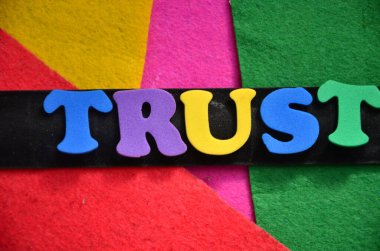 the words trust on abstract colorful background