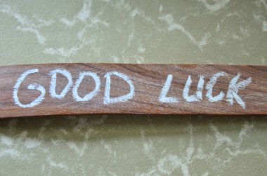 the word luck on a wooden table