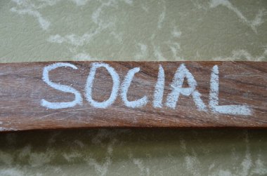 Gri arka planda ahşap harflerle sosyal sözcük.