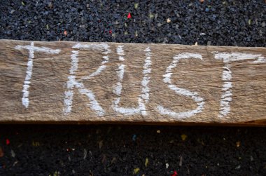 trust word written with wooden blocks on a stone table