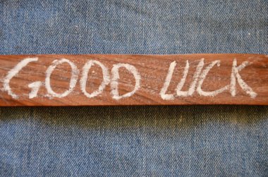 wooden sign with the words luck