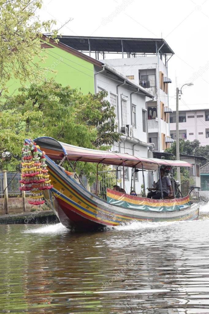 Thailand, Bangkok - March 2016: Longtail taxi boat traveling along the side canals of the city