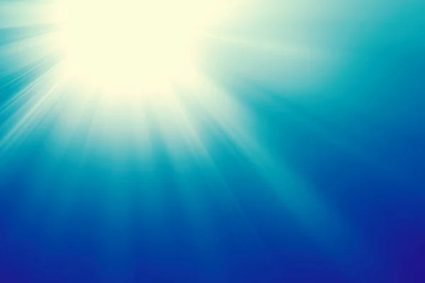 Sun on a blue sky with rays and flare, abstract background — Stock Photo, Image