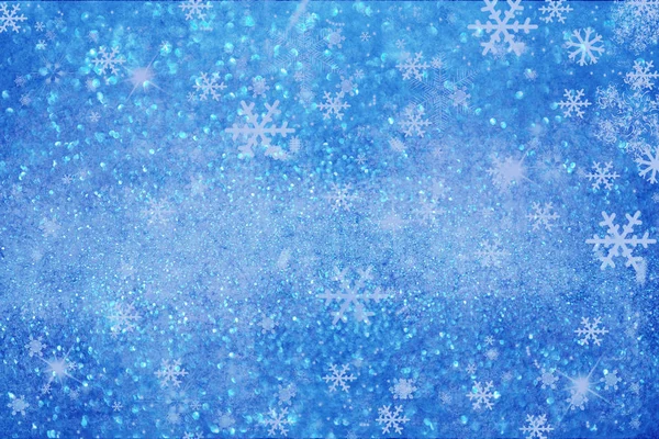 Christmas background with white blurred and clear snowflakes on