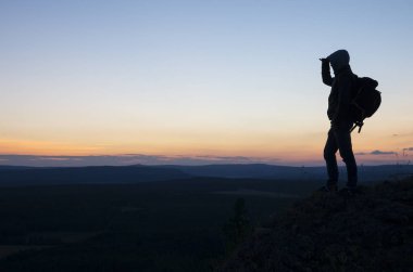 Adam günbatımı dağın tepesinde olduğunu.