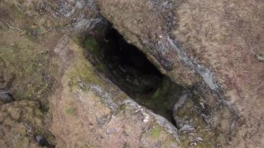 Sumgan-Kutuk karst cave. Descent cavers in the cave. Aerial view.