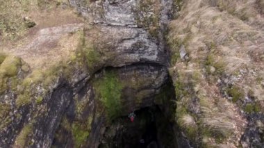 Sumgan-Kutuk karst cave. Descent cavers in the cave. Aerial view.