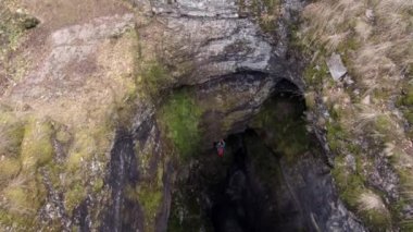 Sumgan-Kutuk karst cave. Descent cavers in the cave. Aerial view.