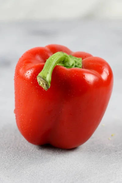Red bell pepper on gray background. Paprika