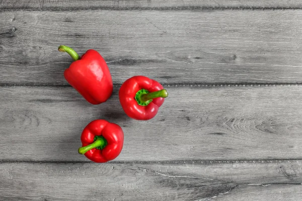 Tabletop View Three Bright Red Bell Peppers Gray Wood Desk — Stock Photo, Image