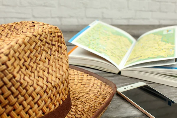 Straw Hat Guide Book Map Mobile Phone Gray Wood Desk — Stock Photo, Image