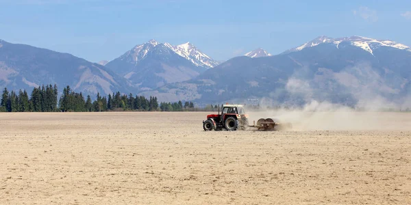 Tractor Pulling Rollers Dry Fields Spring Mountains Little Snow Background — Stock Photo, Image