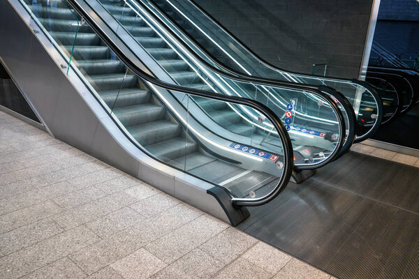 Lower floor near illuminated empty escalators in modern building