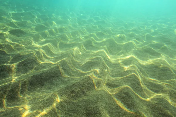 Havs botten, sand "sanddyner" upplyst av sol, turkos vatten i avstånd — Stockfoto