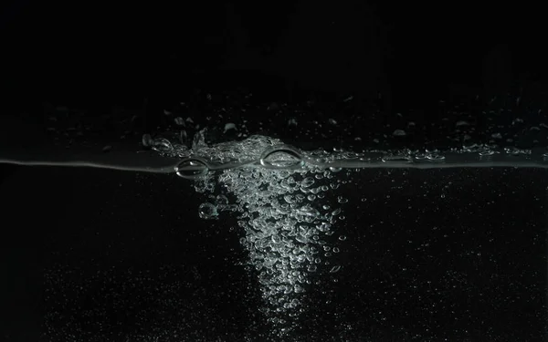 Víz fröccsenő, ahogy ömlött az akvárium tartály, fekete háttér — Stock Fotó