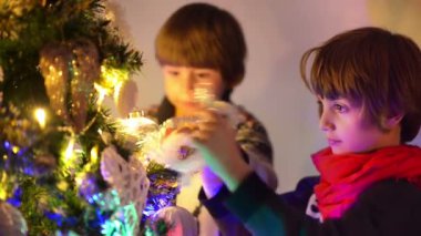 Sevimli küçük çocuklar Noel için hazırlanıyor, Noel ağacı süsleme