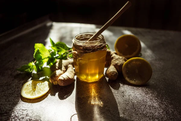 honey with lemon, ginger and mint for health as prevention of colds in the sunlight 1