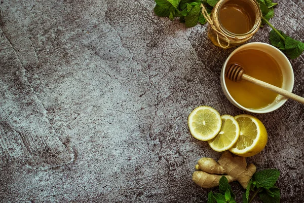 honey, lemon, mint, ginger, oatmeal - home remedy to prevent colds on a gray background 1