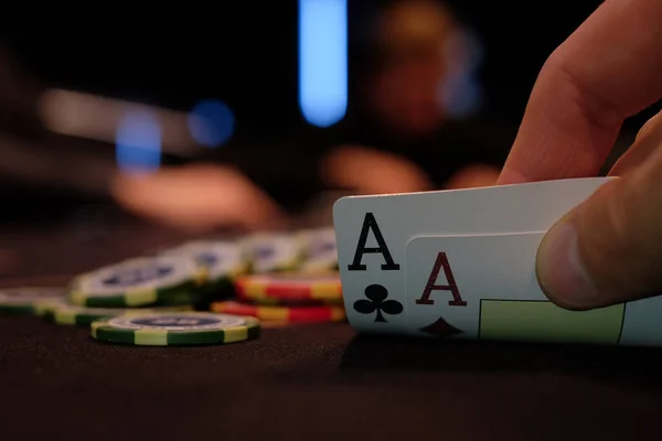 Dealer or croupier shuffles poker cards in a casino on the background of a table, chips. Concept of poker game, game business. Playing for money, a big win, a jackpot, gambling, a desire to get rich.