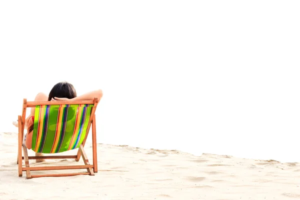 A women sleep on beach chair.