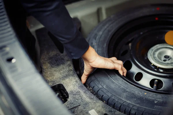 Close Mechanic Hand Taking Spare Tire Boot — Stock Photo, Image