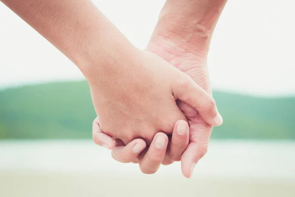 stock image the people hold one's hand to showing love relationship.