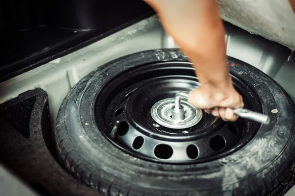 Close Mechanic Hand Taking Spare Tire Boot — Stock Photo, Image