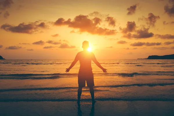 Silhouette of Man Raising His Hands or Open arms  with sunset, sunlight.