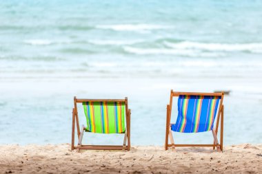 plaj sandalyesi deniz suyu yakınında plajda.