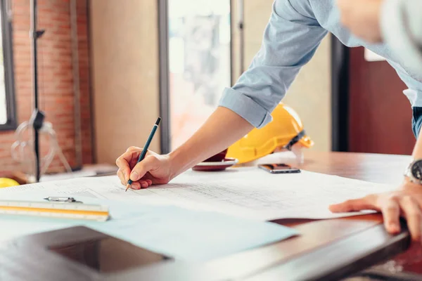 Engineers Holding Pen Pointing Building Drawing Outlay Construction Plan Guide — Stock Photo, Image