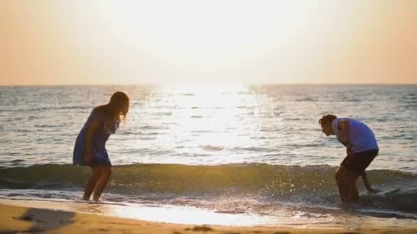 Ungt Par Kärlek Stänk Havsvatten Nära Sandstrand Mot Kvällssolen Bildmässigt — Stockvideo