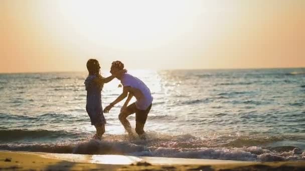 Young Man Runs Girlfriend Lifts Spins Girl Water Reflecting Evening — Stock Video