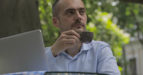 Young Businessman Drinks Hot Coffee Looks Table Laptop Summer Cafe — 비디오