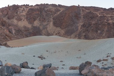 Volkanik kum farklı renklerdedir. Tenerlife adasının tepesindeki dağın zirveleri arasında bir düzlüktedir.