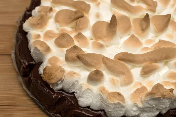 Finished chocolate meringue cake after baking, golden meringue details