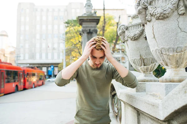 Depressive man by the wall with anxious and displeased feelings. Negative emotions.Stress and depression concept.