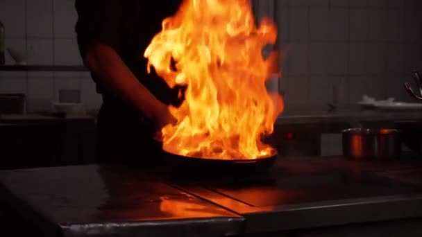 Cooking in wok pan with hard fire burning in slow motion — Stock Video