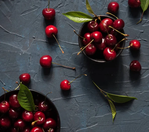 Cherry berry red bowl dark background skate summer fresh top view