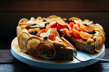 Makro görünümü lezzetli vejetaryen narenciye pastadan taze portakal ve kuru baharat, tarçın ve kahverengi ahşap masa üzerinde Yıldız anason ile dekore edilmiştir. Seçici odak. Renkli, sağlıklı ve sulu. Cafe menü veya şekerleme Katalog için görüntü